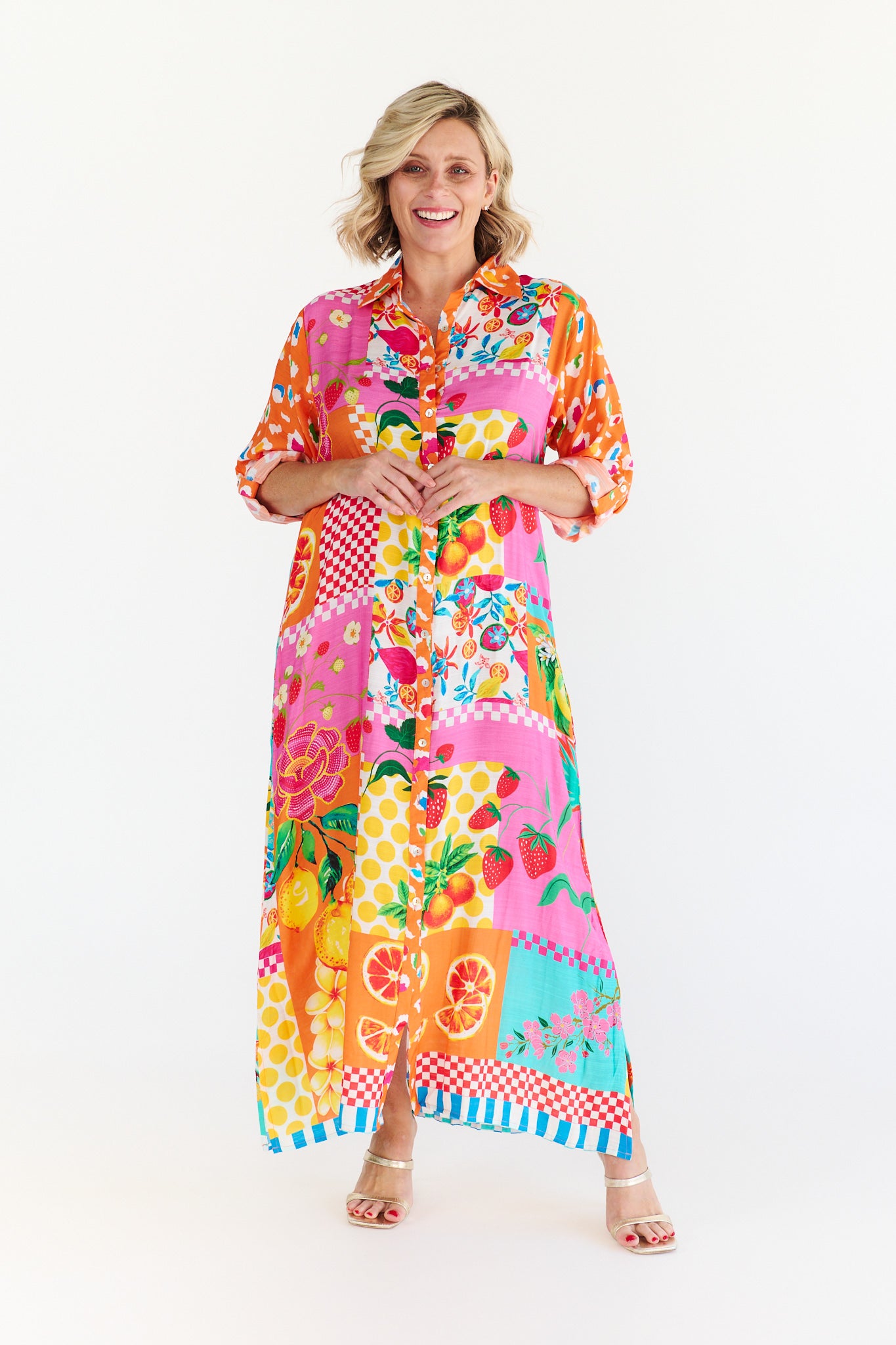 Woman wearing a colorful patterned dress on a white background